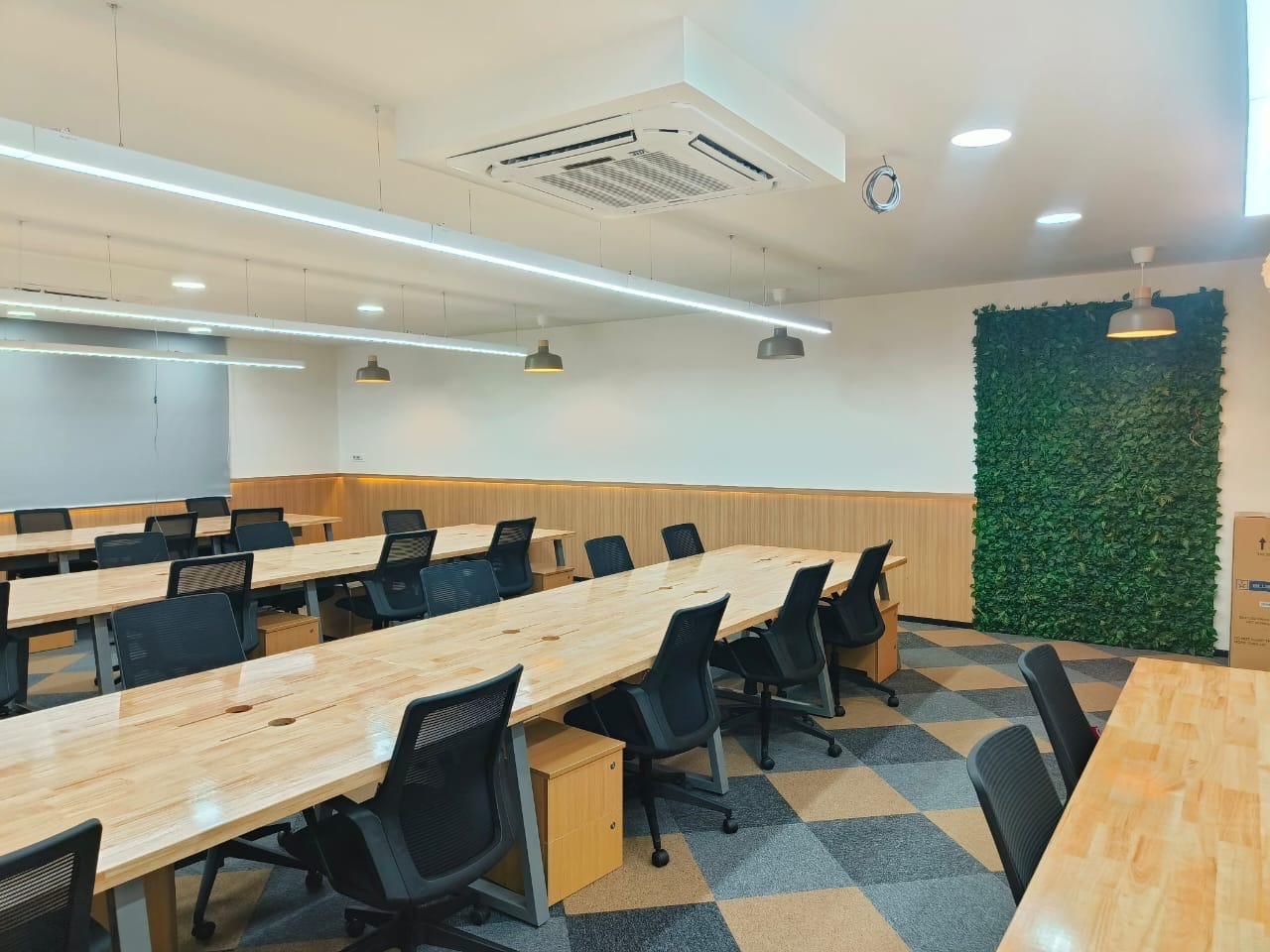 BHIVE Workspace Koramangala open desks with a live green wall